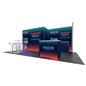 2013 20’ x 10’ Gravitee™ trade show booth rental shown from the right to show a backwall set back with two 90 degree panels from a second backwall to the left. There is a small work station in front of the recessed wall and a larger backlit counter in front of that.