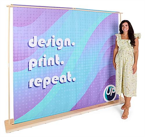 Custom printed backwall with wooden frame with woman in front
